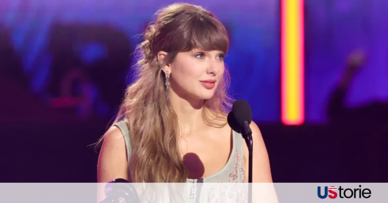 Taylor Swift holding her trophy at the iHeartRadio Music Awards while smiling during her acceptance speech.