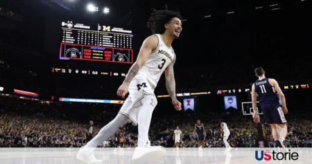 Michigan Wolverines players celebrating under a shower of confetti after winning the NCAA national championship game against UConn.