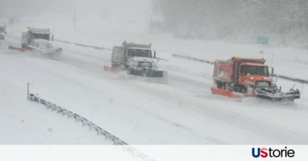 Snow-covered mountain highway in the Western U.S. during a severe winter storm warning.