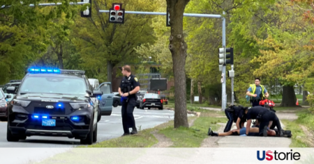Gunman Fires into Busy Cambridge Traffic, Leaving Two Critically Injured Police tape blocking off Memorial Drive in Cambridge; Massachusetts State Police cruisers on the scene; The Boston skyline seen from the riverfront road