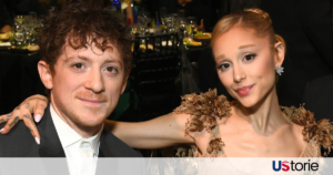 riana Grande and Ethan Slater smiling together at a promotional red carpet event for the movie adaptation of Wicked.